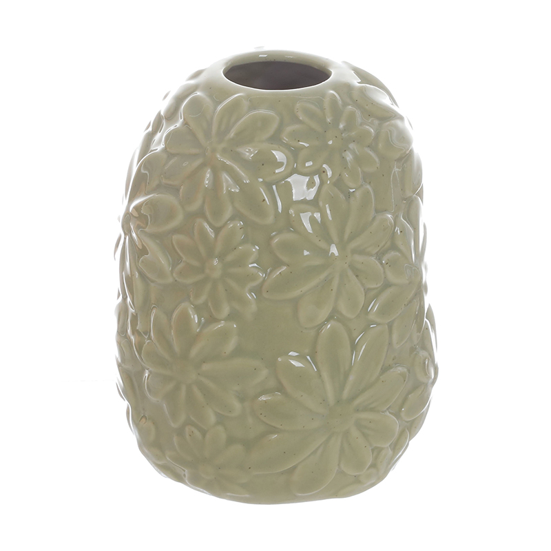 A green ceramic vase with floral prints